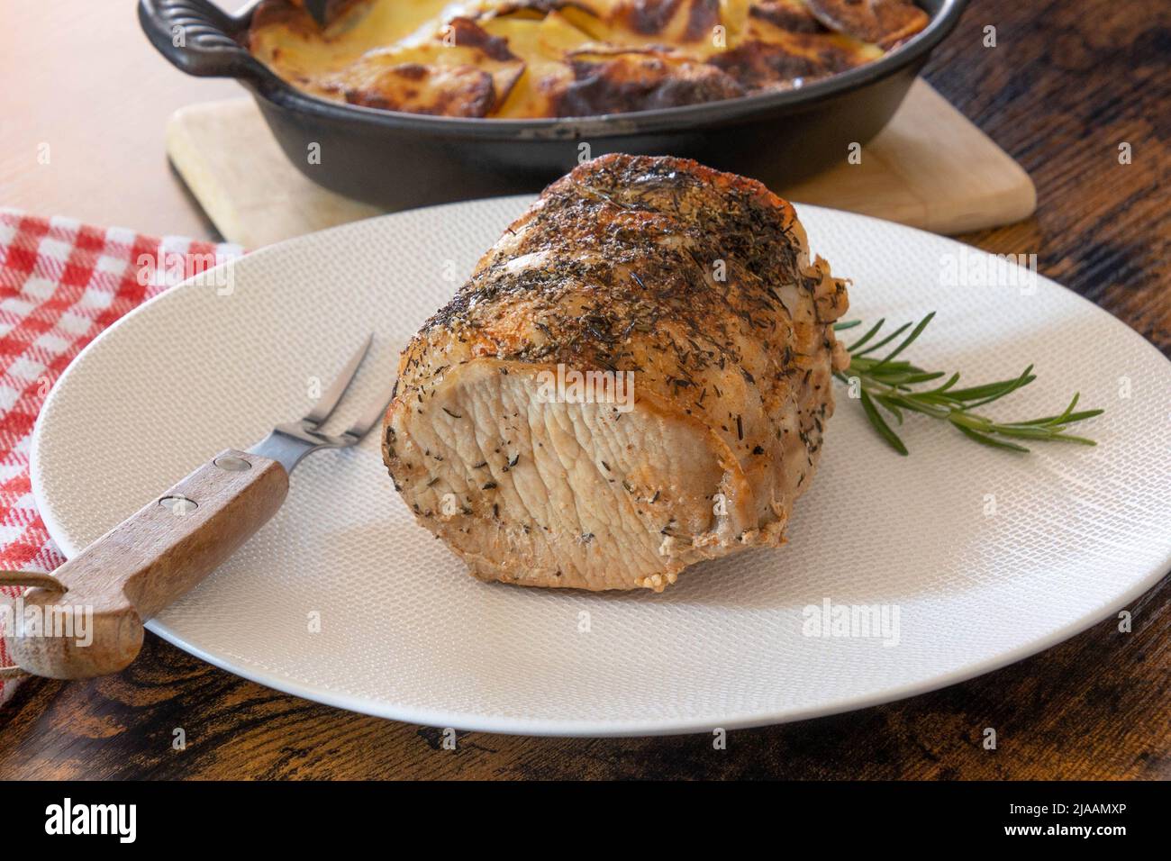roast pork with gratin dauphinois on a table Stock Photo - Alamy