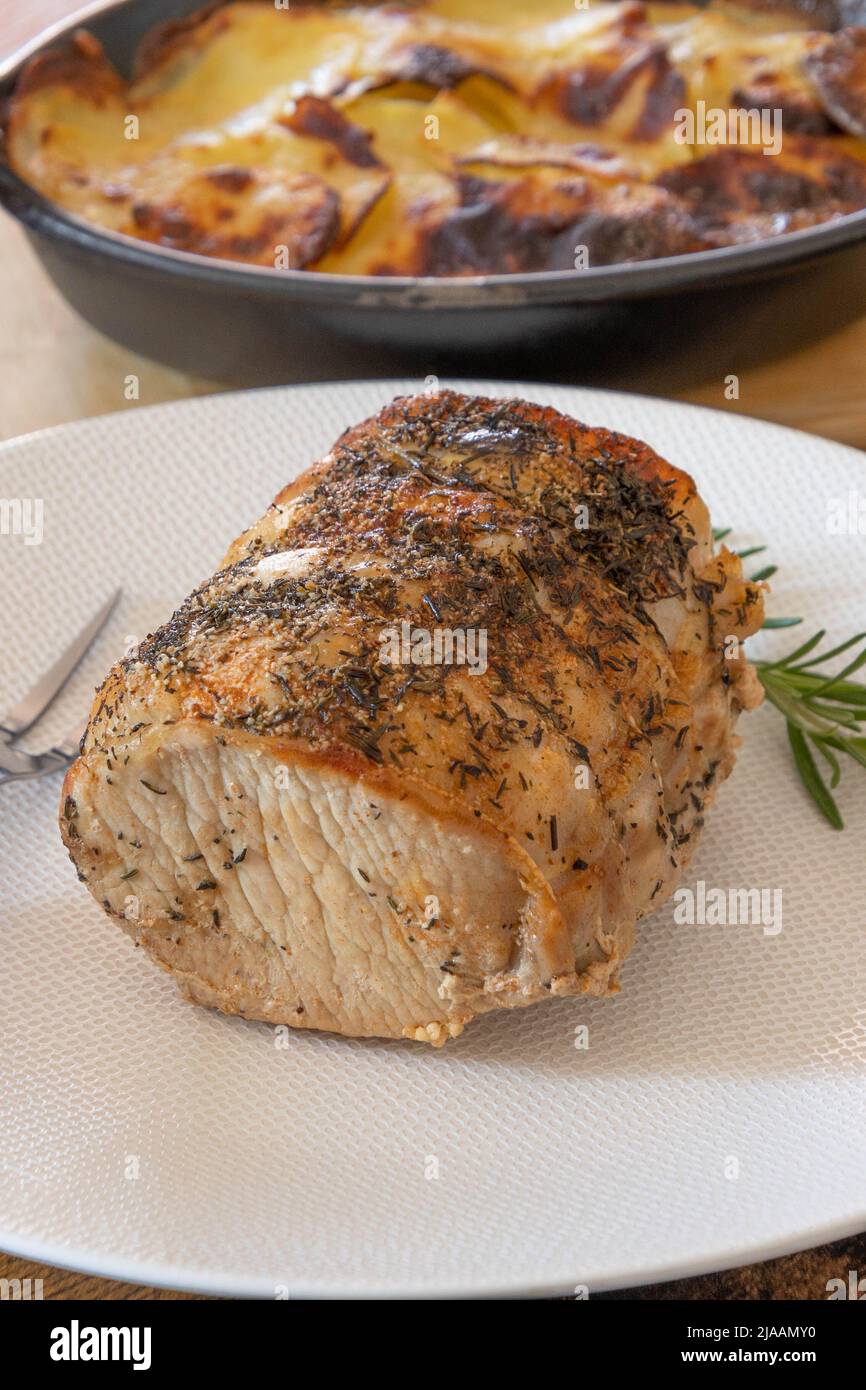 roast pork with gratin dauphinois on a table Stock Photo - Alamy
