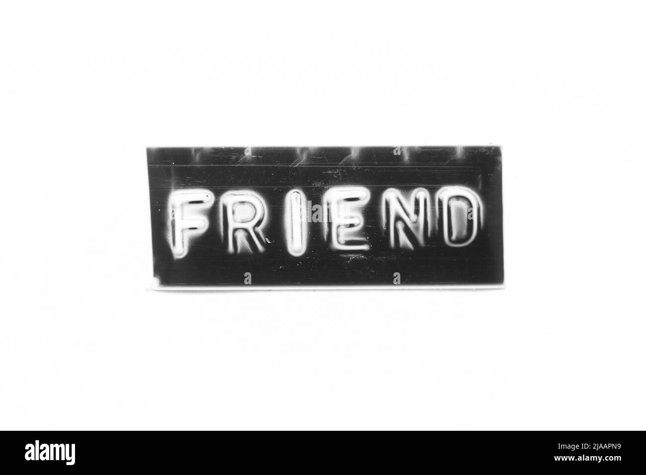 Black color banner that have embossed letter with word friend on white paper background Stock Photo