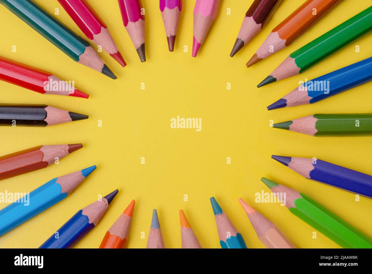 a few colored pencils on a yellow-blue background Develop creativity Get creative Stock Photo