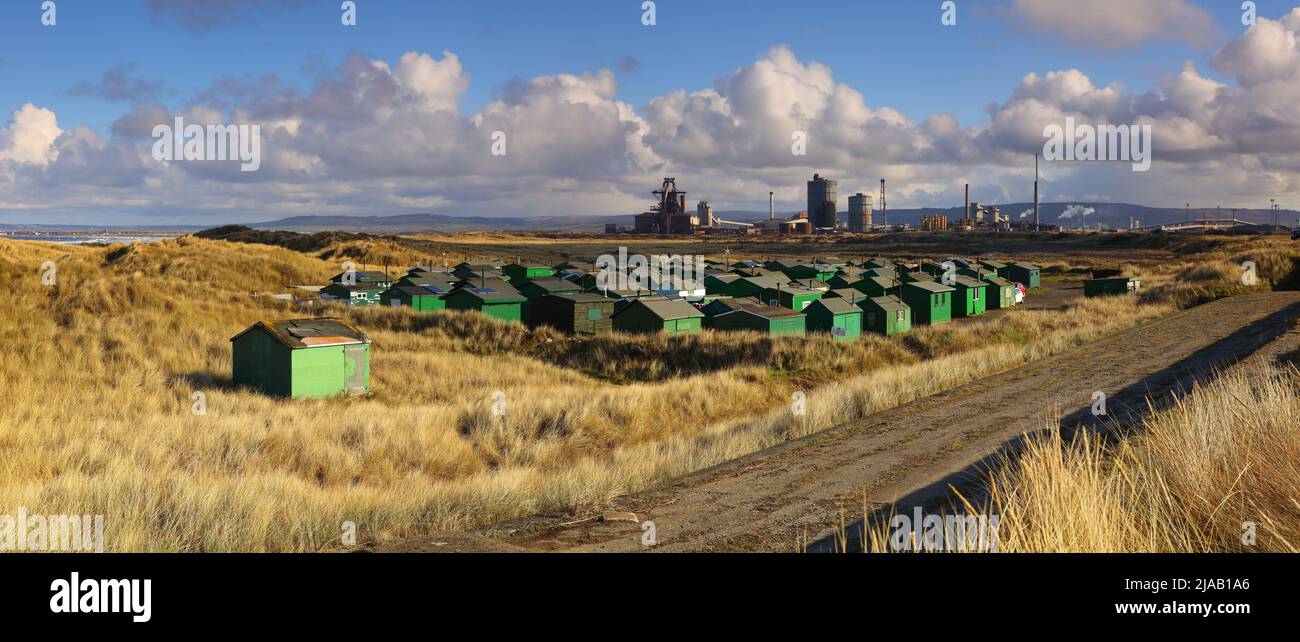Panoramic view of Fisherman's Huts with Redcar Steelworks in the background. South Gare, Redcar, Teesside, North Yorkshire, England, UK. Stock Photo