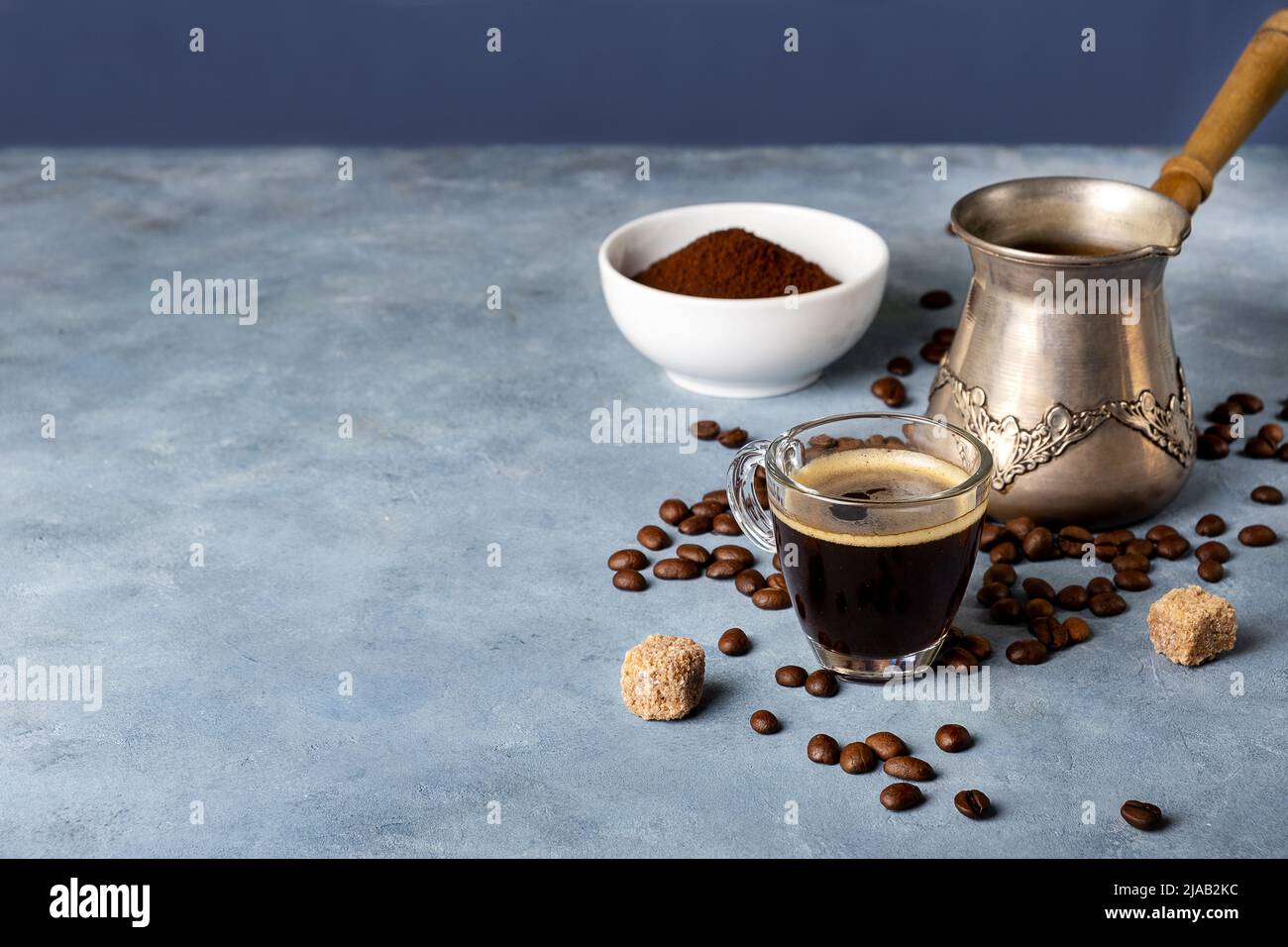 https://c8.alamy.com/comp/2JAB2KC/turkish-coffee-maker-glass-cup-ground-coffee-and-coffee-beans-2JAB2KC.jpg