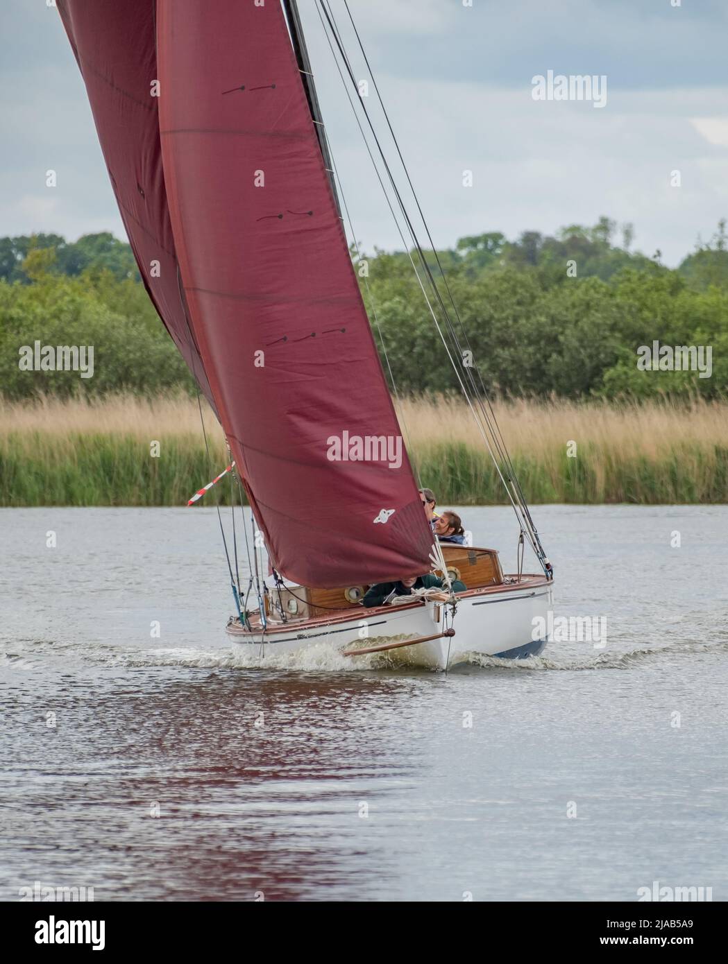 Horning, Norfolk, UK May 28 2022. A traditional river cruiser sailing