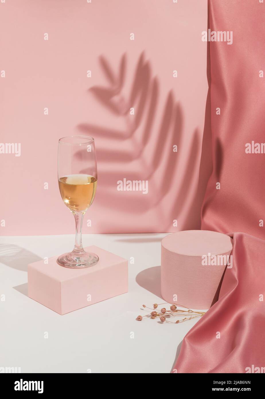Romantic pastel pink Valentine's Day composition with wine glass, satin ...
