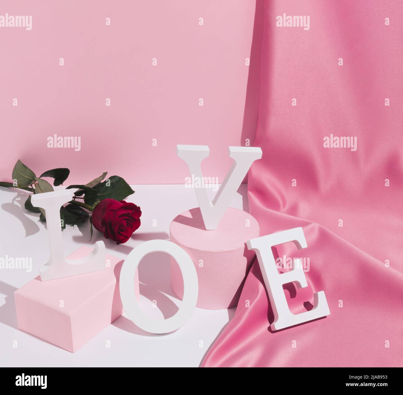 Romantic pastel pink Valentine's Day composition with word Love, satin ...