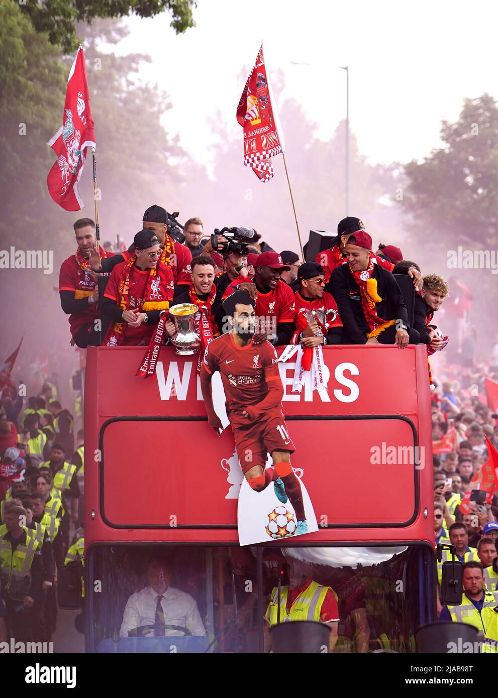 Liverpool players hold a cardboard cutout of Mohamed Salah on an open