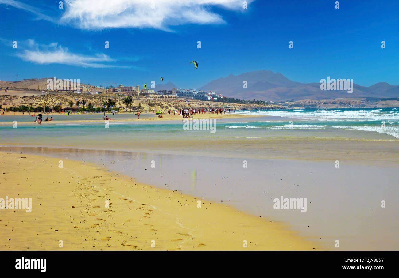 Beautiful lagoon with kite surfers, village Costa Calma, dry hills