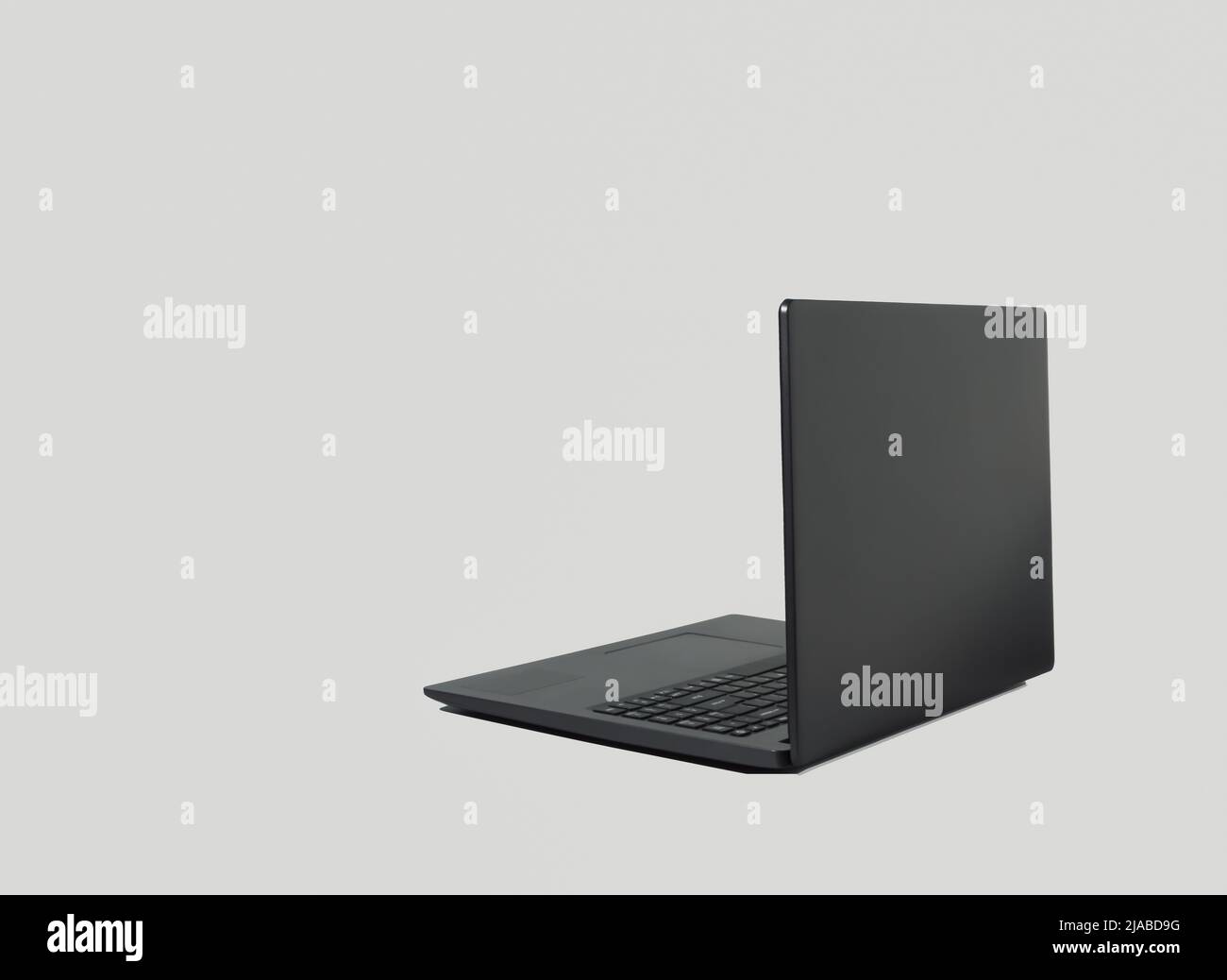 Black lap top computer with shadow isolated on grey background. Copy space. Working from home concept. Stock Photo