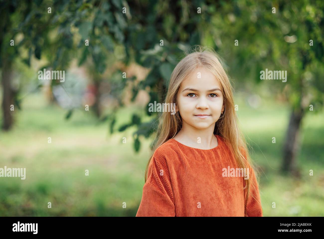 Close up portrait of beautiful little girl with blonde long hair and ...
