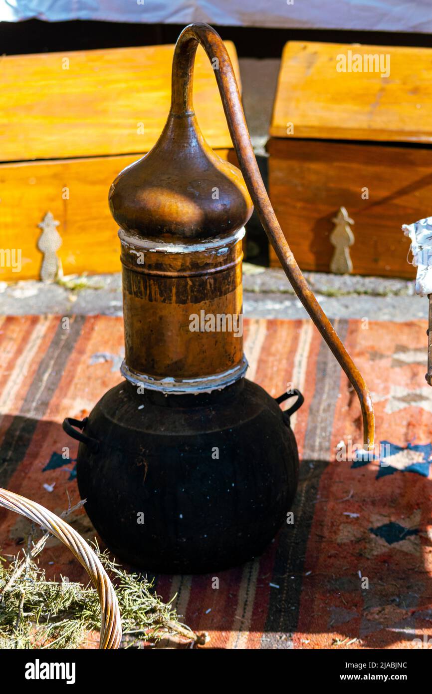 Antique small Alembic, extracting essences from plants or cereals. Old traditions. Stock Photo