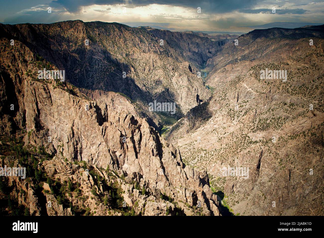 Steep cliffs lead to the Gunnison River through Black Canyon National Park in western Colorado. Stock Photo