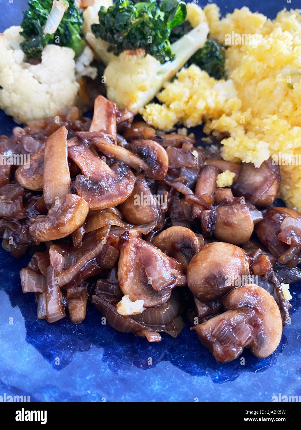 Dish served with mushrooms, broccoli and cabbage and cuz-cuz, typical Brazilian dish. Stock Photo