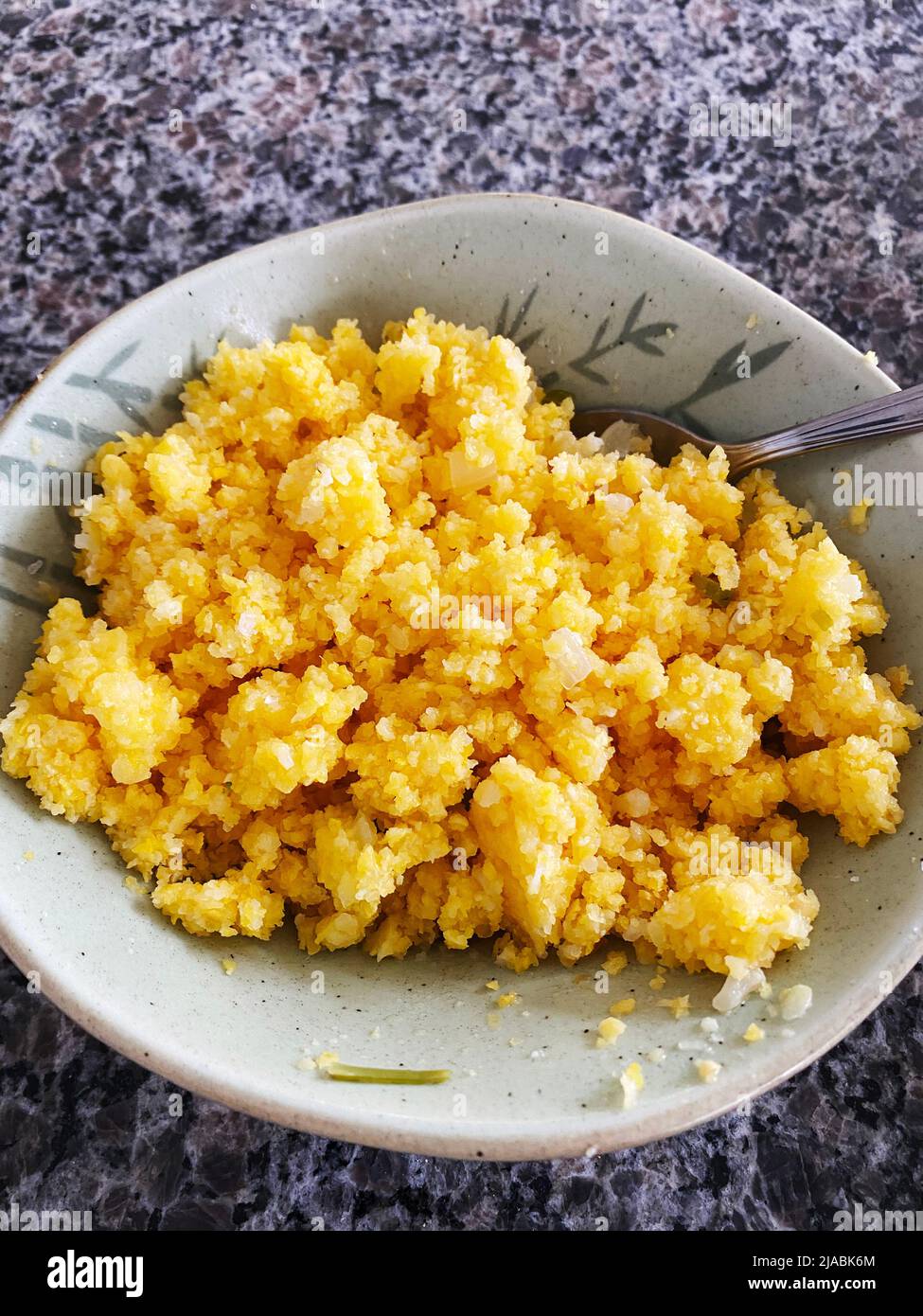 Cuz-Cuz, a dish prepared with large corn flakes, soaked corn, slow steaming and served in butter. Stock Photo