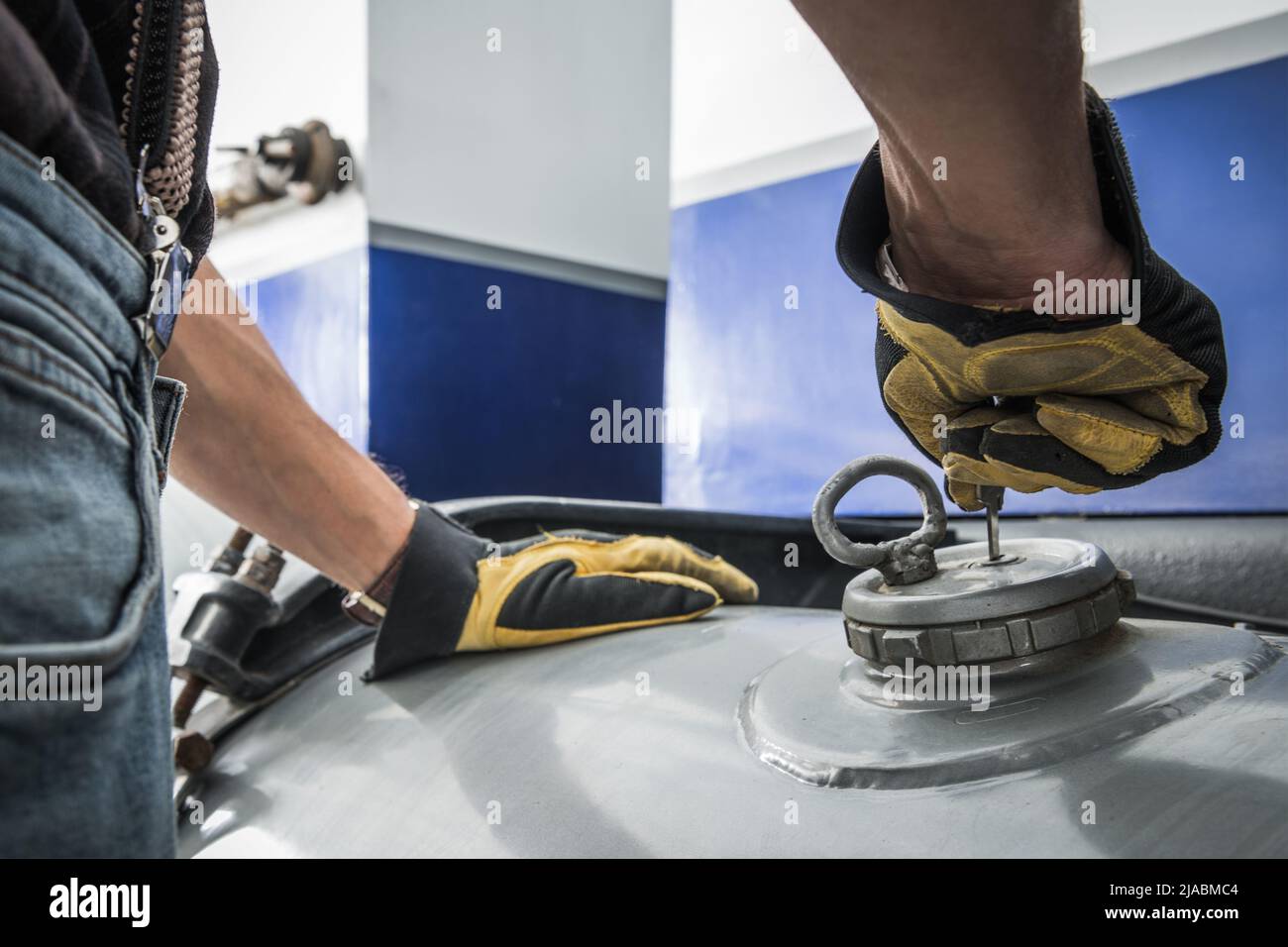 Semi Truck Driver Driving Opening Fuel Cap in His Vehicle. Diesel Fuel Tank. Transportation Theme. Stock Photo
