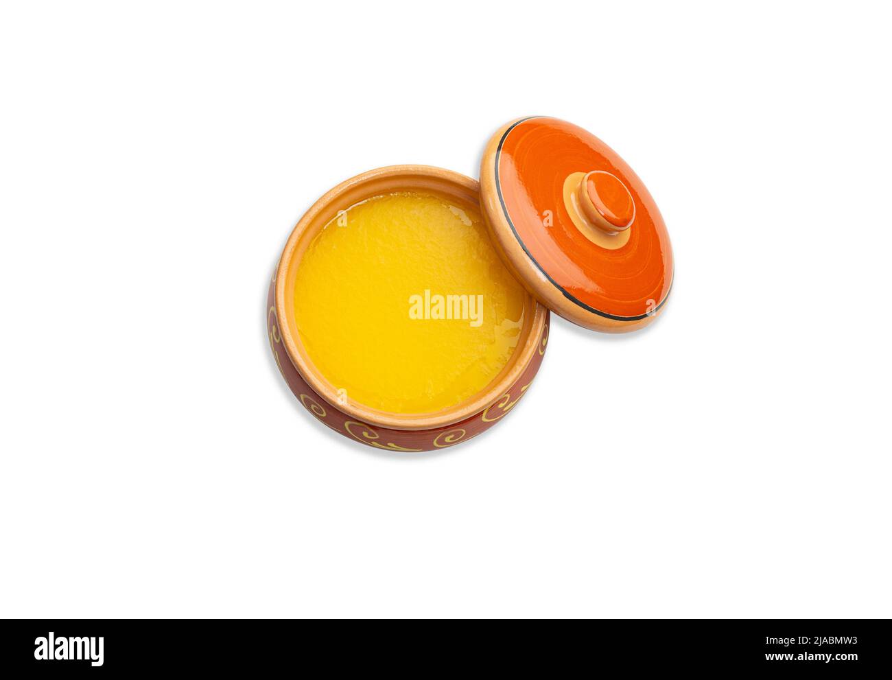 Homemade ghee in a ceramic pot. Isolated white background. Top view. Stock Photo