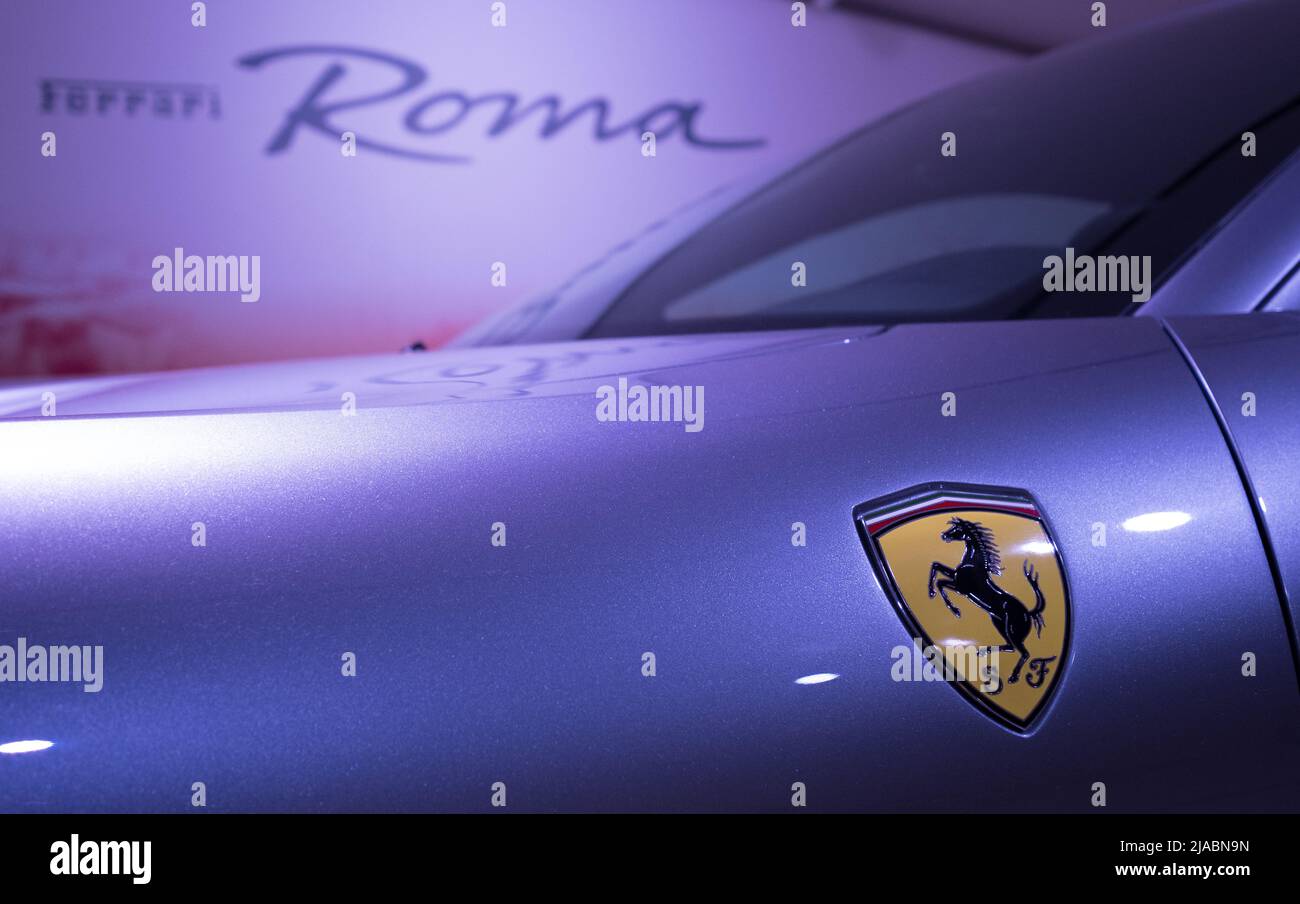 Modena, Italy - July 14, 2021: Prancing horse Yellow Logo on the Ferrari Roma type F169 model Gray front wing high-performance Italian sports car in M Stock Photo