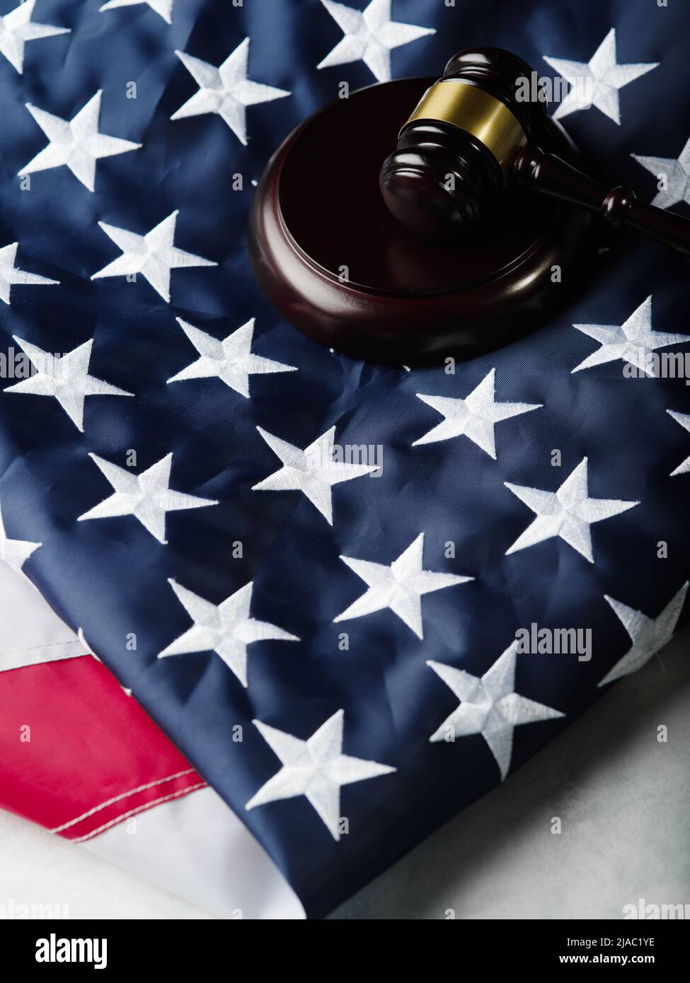 Against the background of the American flag, the judge's wooden gavel. Legitimacy, law, justice, judicial system, constitution, law. There are no peop Stock Photo
