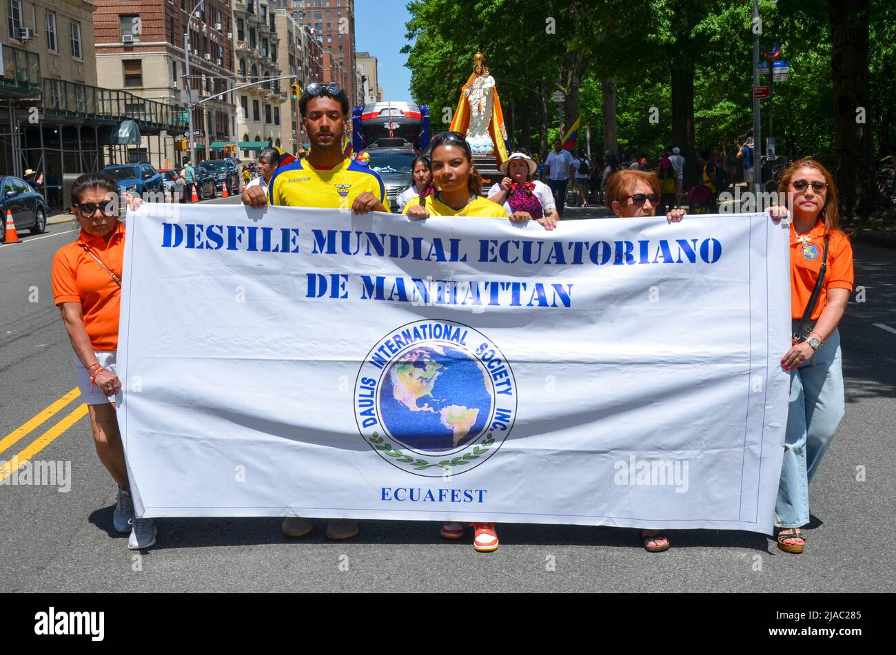 Participants honding banner, march way up Central Park West in New York