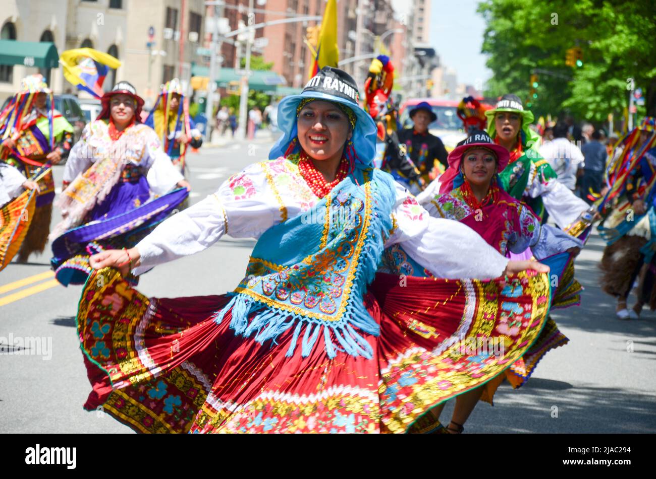 Girls are seen dancing with traditional Ecuadorian outfits during the