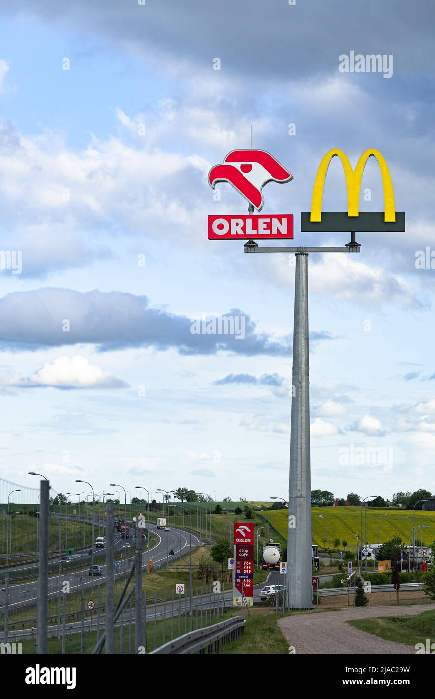 Rusocin, Poland - May 27th, 2022: Orlen petrol station and McDonald's restaurant logos on rest area on A1 highway or motorway in Poland Stock Photo