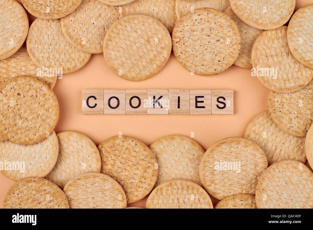 Creative flat lay with round healthy cookies and wood cubes with text