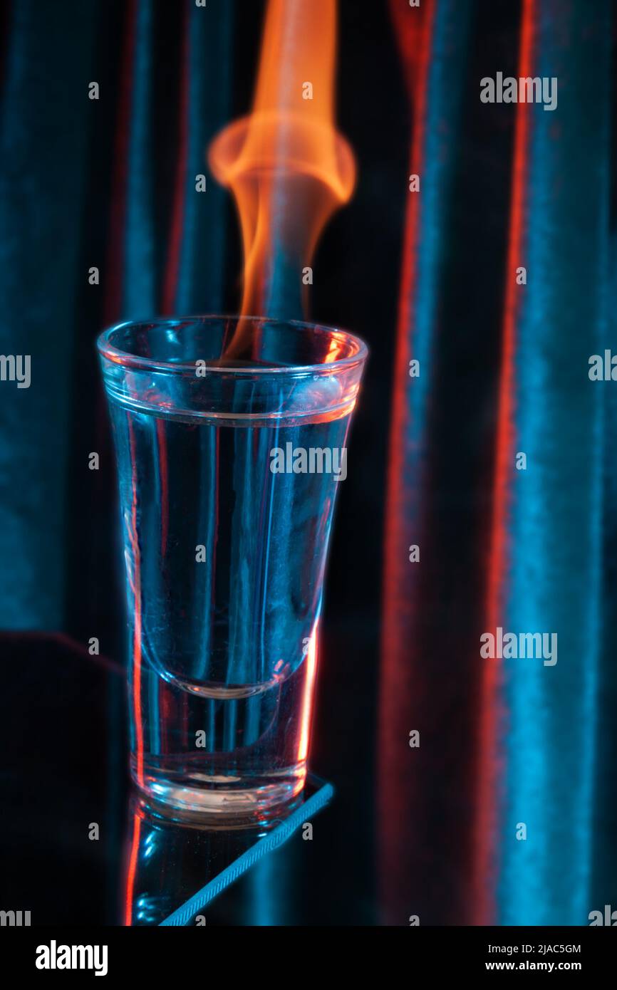 Glass of Mexican tequila, vodka with burning liquid. Glass of vodka on