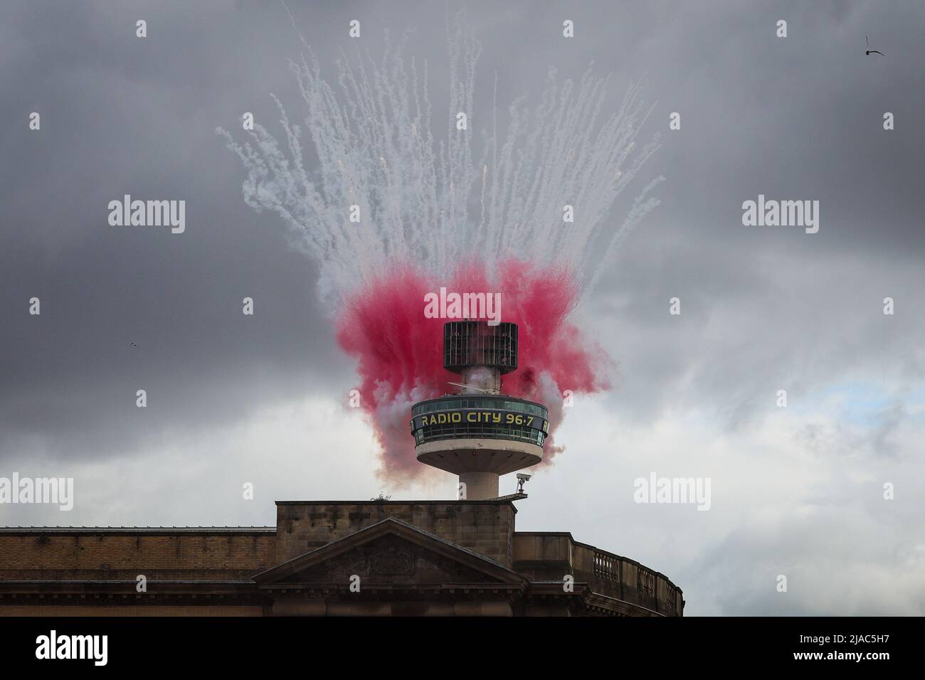 Liverpool, UK. 29th May, 2022. The Radio City 96.7 lets off fireworks and flares as the Liverpool FC squad celebrate during the open top bus parade through the city after winning both the Carabao Cup and the FA Cup in the 2021/22 season in Liverpool, United Kingdom on 5/29/2022. (Photo by James Heaton/News Images/Sipa USA) Credit: Sipa USA/Alamy Live News Stock Photo