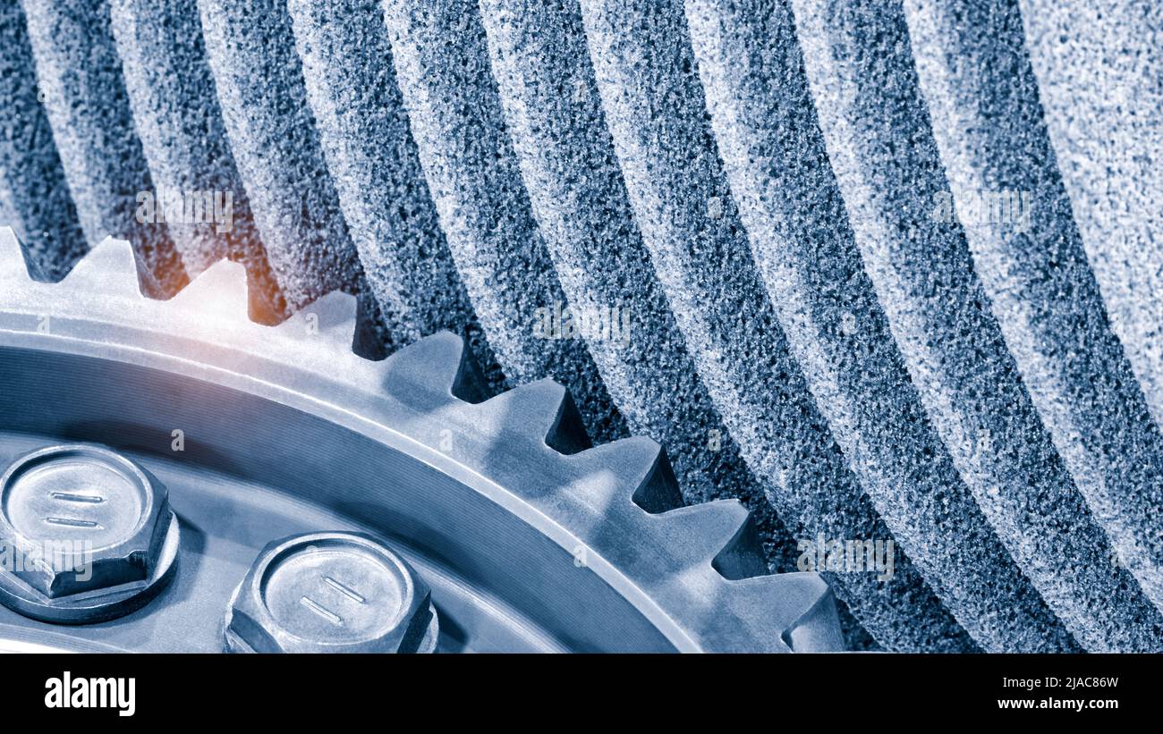 Gear cutting production, sharpening the worm cutter on the sharpening machine with an abrasive stone. Close-up, industrial metalworking concept Stock Photo