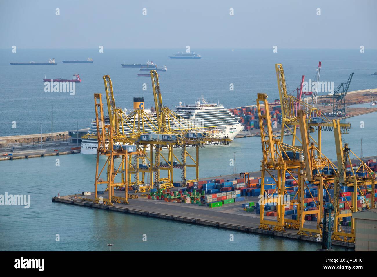 erial view of Barcelona port with harbour cranes and ruise ship. Barcelona, Spain Stock Photo