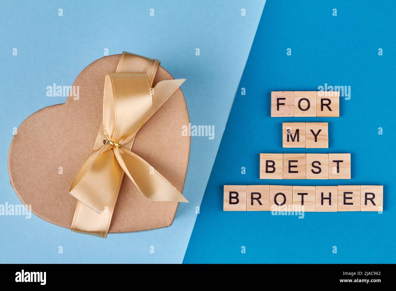 Gift gift box and wooden cubes with inscription For my best brother. Flat lay composition on blue background. Stock Photo
