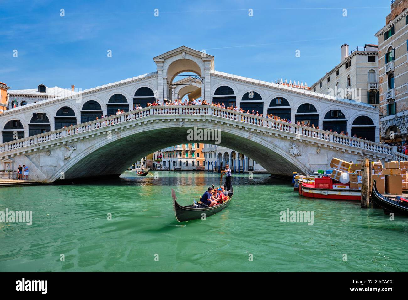 Rialto bridge with boats and gondolas. Grand Canal, Venice, Italy Stock Photo