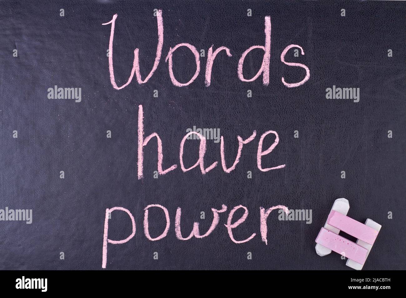 Words have power inscription written with chalk on black board. Inspiration and motivation concept. Stock Photo