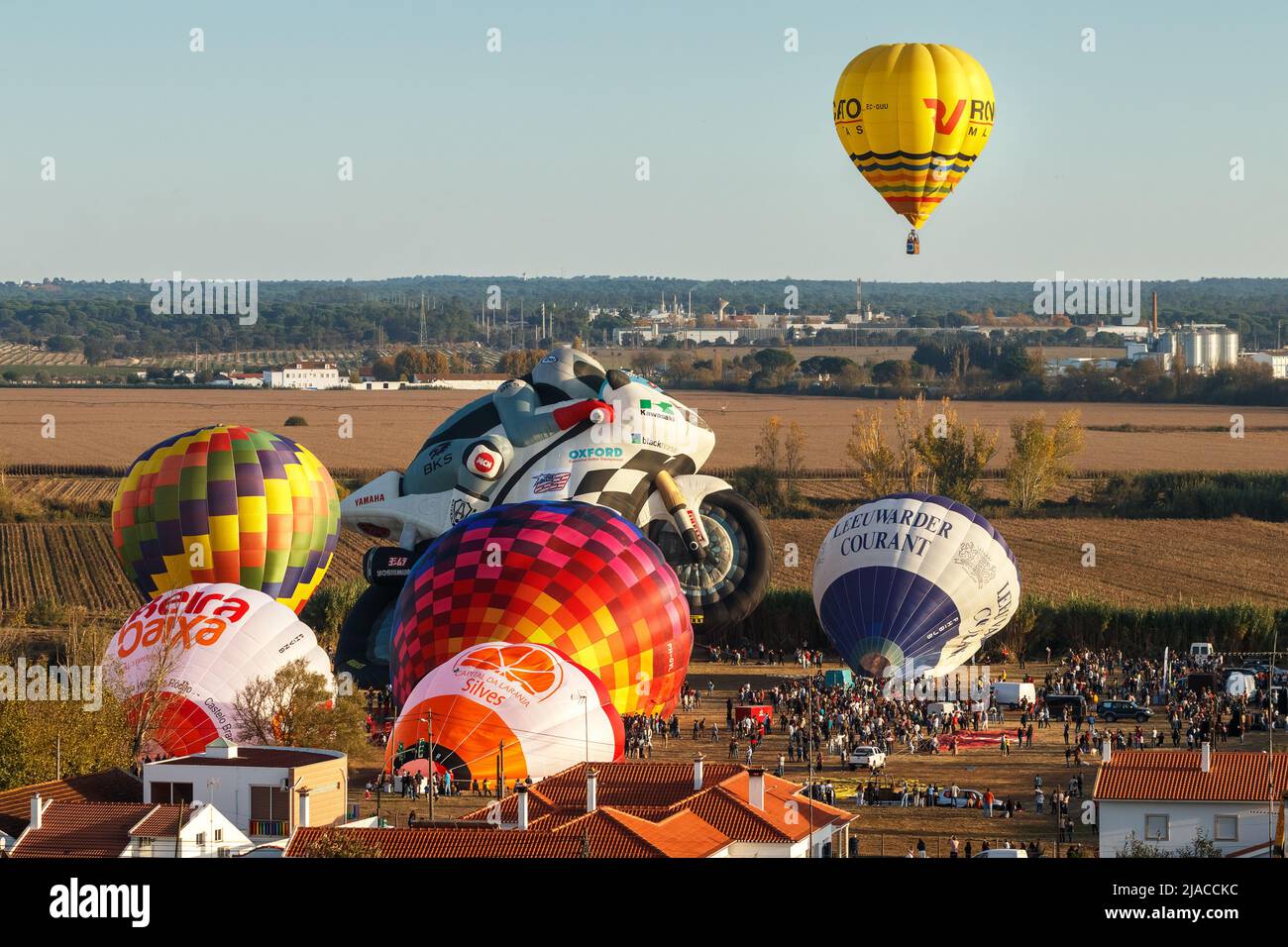 Coruche, Portugal - November 13, 2021: Hot air balloon flying and other balloons being inflated at the Ballooning Festival in Coruche, Portugal. Stock Photo