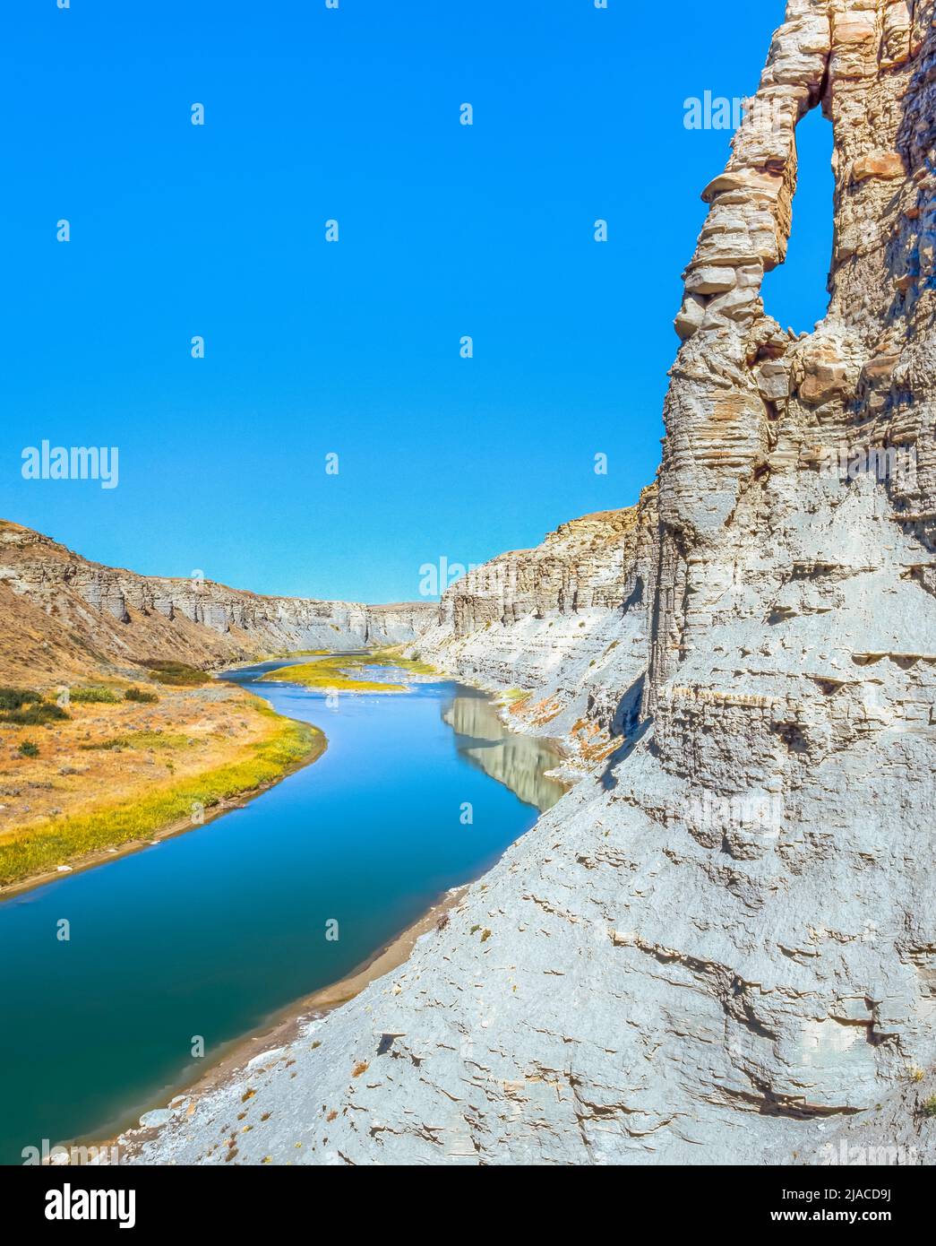 arch on a cliff above two medicine river in a deep canyon near valier, montana Stock Photo Alamy