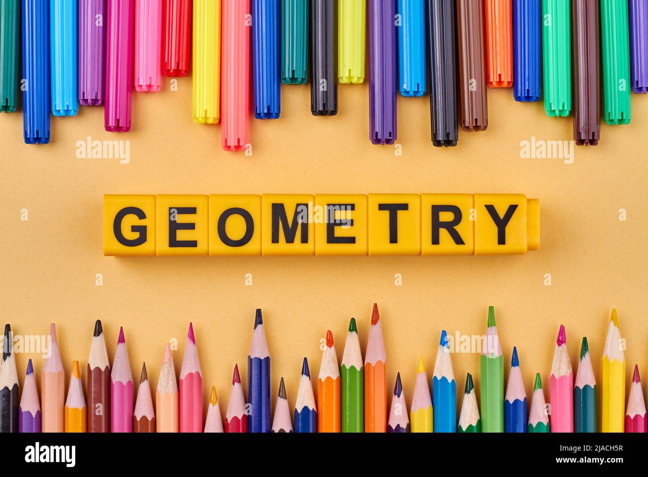 The word GEOMETRY written on plastic cubes in frame from colored school