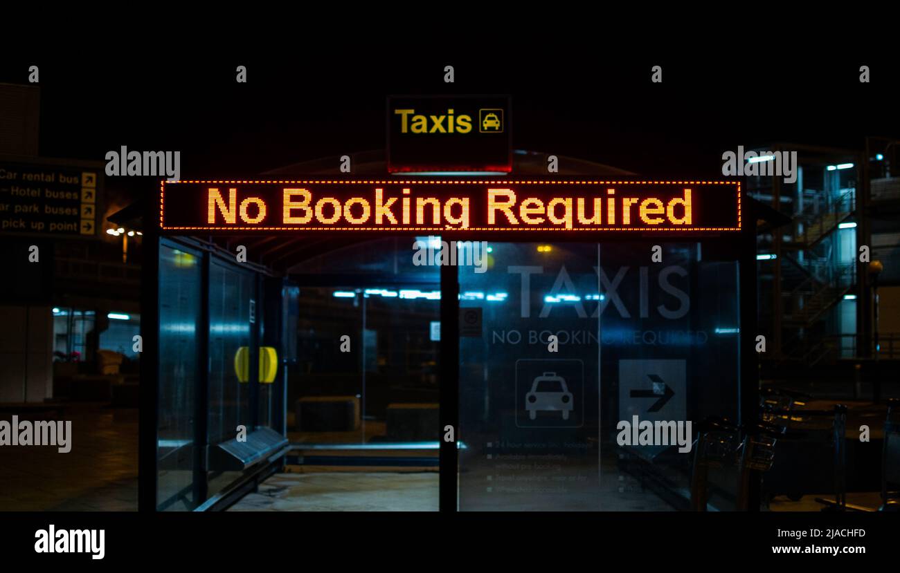 Taxi shelter stating 'No Booking Required' in Manchester International Airport, Greater Manchester, united Kingdom. Stock Photo