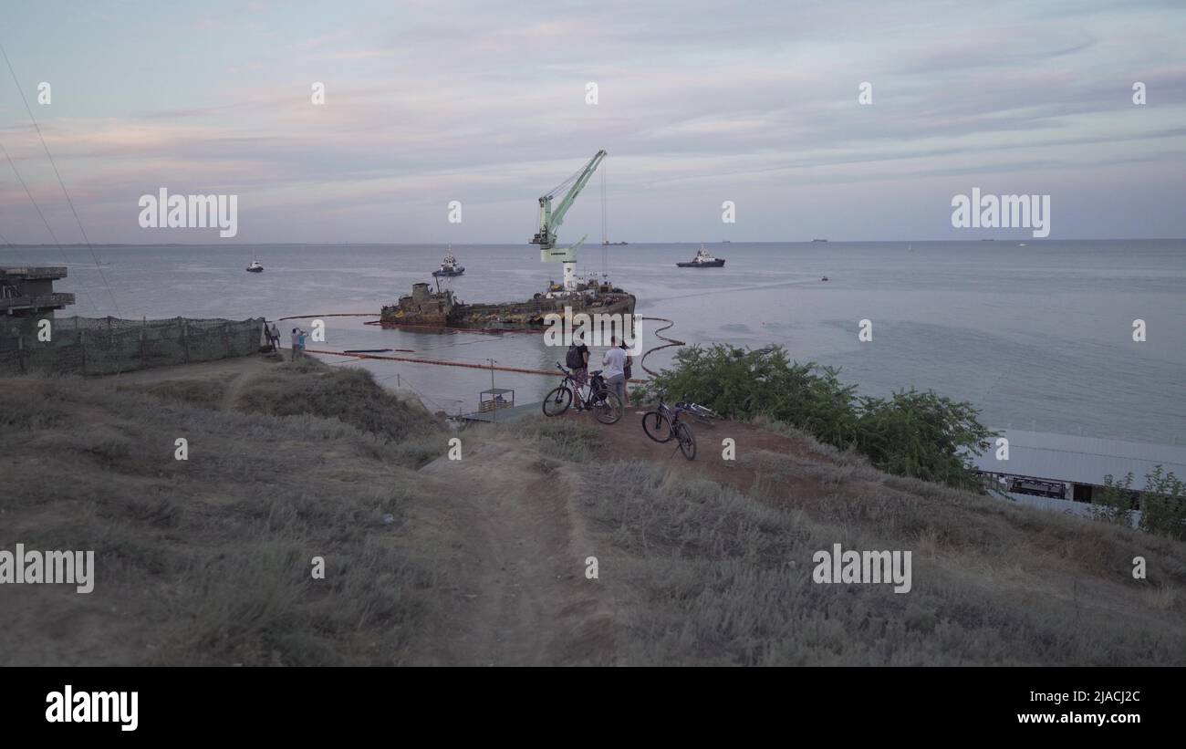 Oil tanker Delphi crashed near Black Sea coast in Ukraine, Odessa 26 August 2020. Small tanker, rusty old, lies on its side in sea. Lifting sunken shi Stock Photo