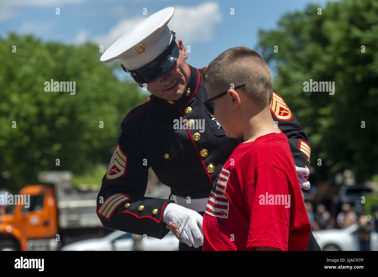 Washington, United States. 29th May, 2022. Staff Sgt. Tim Chambers, known as 'The Saluting Marine', .shakes hands with a boy who helped in saluting the thousands of motorcyclists participating in 'Rolling Thunder,' a demonstration to bring awareness to prisoners of war and military members missing in action, in Washington, DC on Sunday, May 29, 2022. Photo by Bonnie Cash/UPI Credit: UPI/Alamy Live News Stock Photo