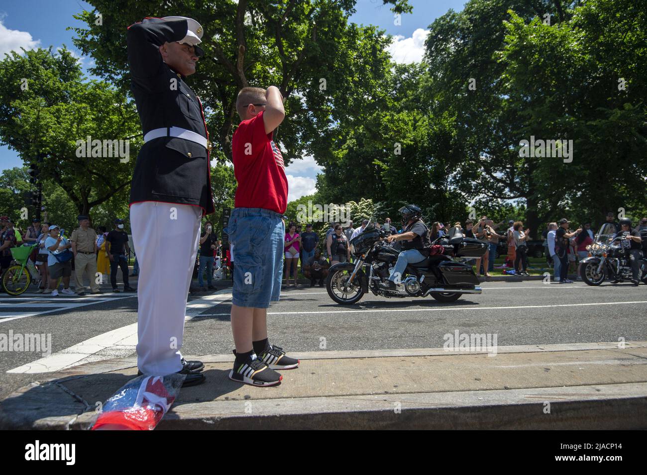 Washington, United States. 29th May, 2022. Staff Sgt. Tim Chambers, known as 'The Saluting Marine', is joined by a boy in saluting the thousands of motorcyclists participating in 'Rolling Thunder,' a demonstration to bring awareness to prisoners of war and military members missing in action, as they ride past the Lincoln Memorial in Washington, DC on Sunday, May 29, 2022. Photo by Bonnie Cash/UPI Credit: UPI/Alamy Live News Stock Photo