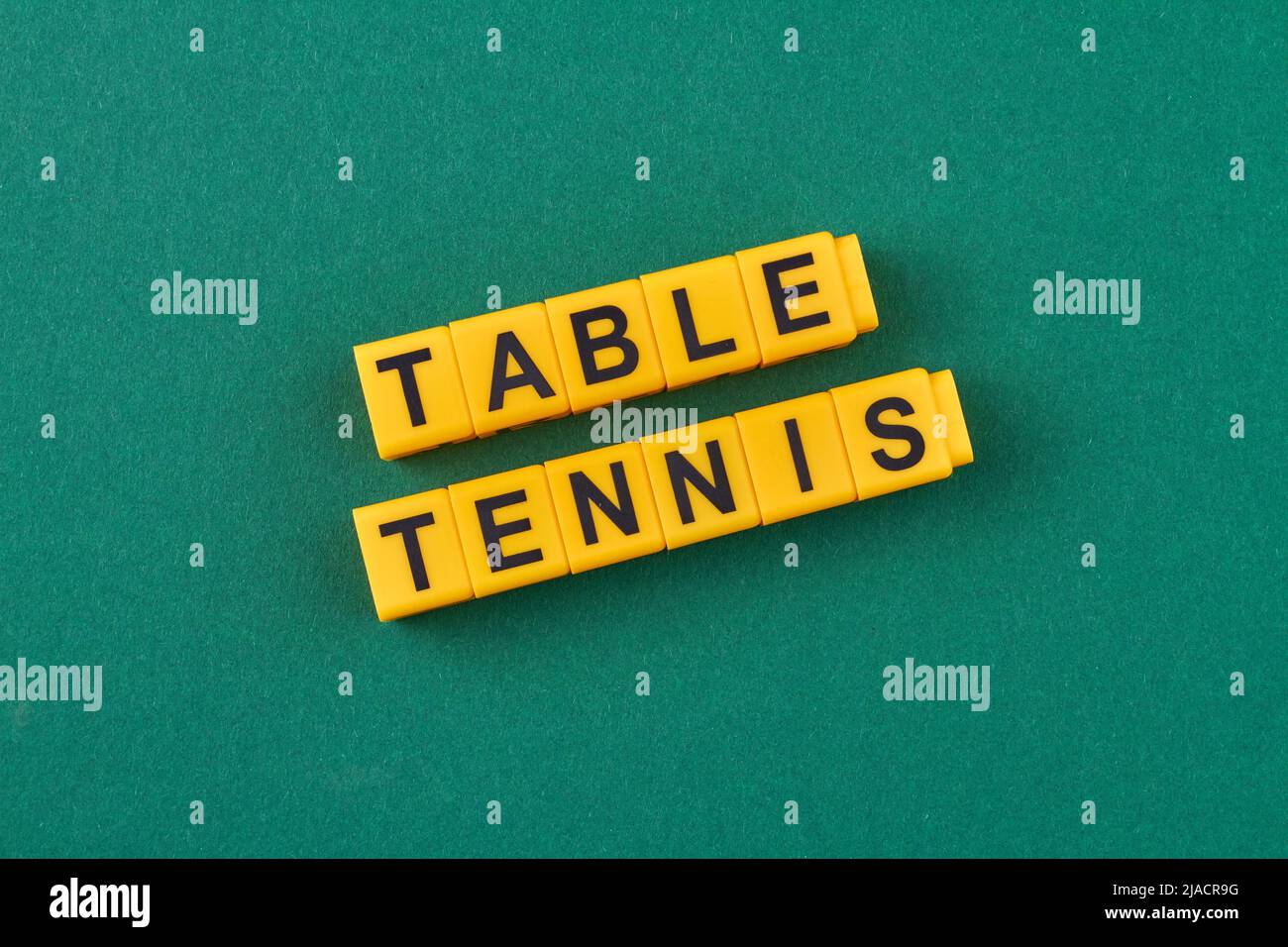 The inscription table tennis written on yellow cubes against green ...