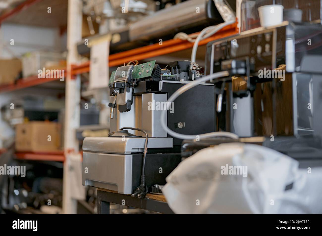 Warehouse with broken coffee machines ready to repair Stock Photo Alamy