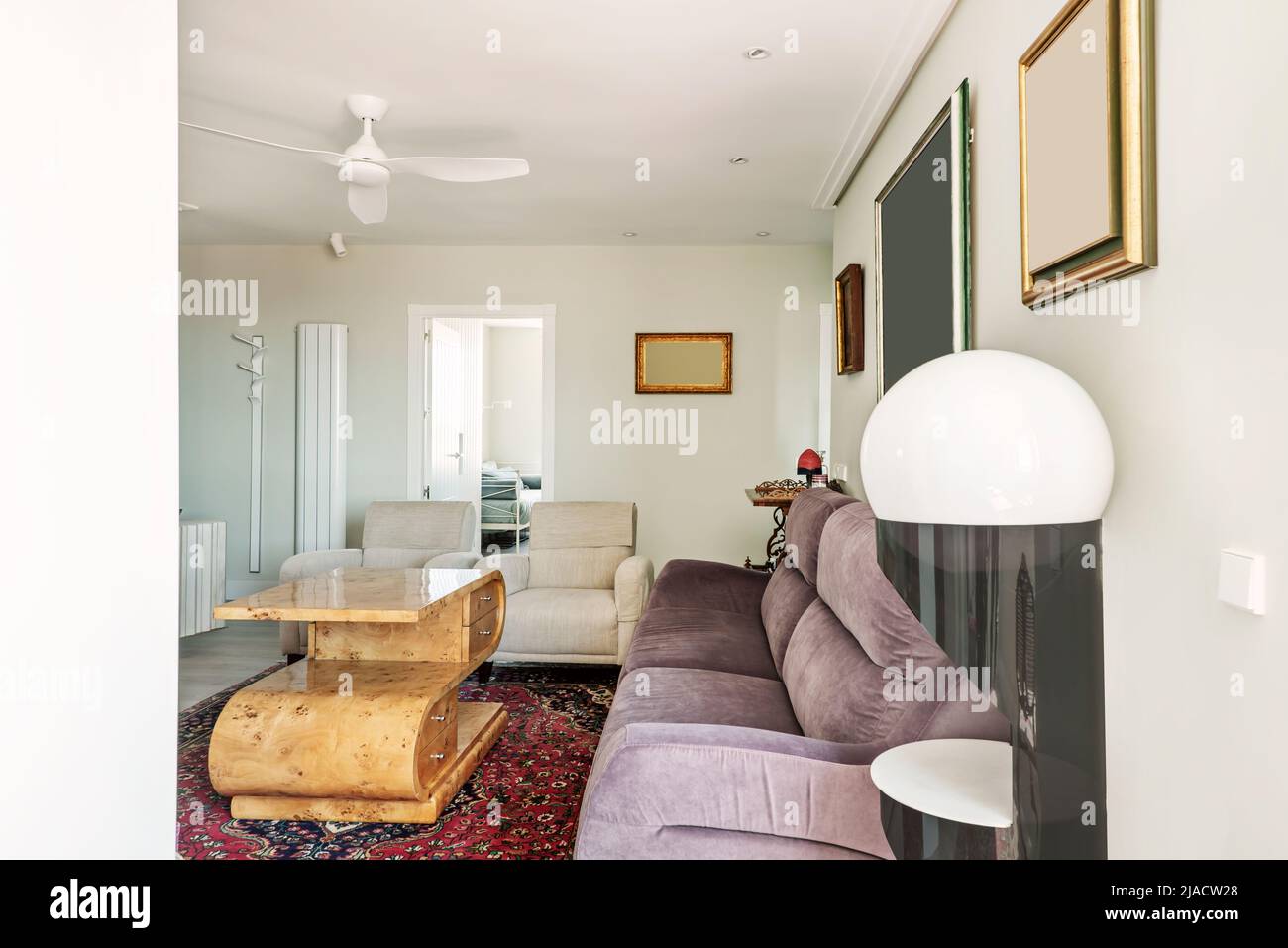 Living room with decorative furniture and white ceiling fan Stock Photo