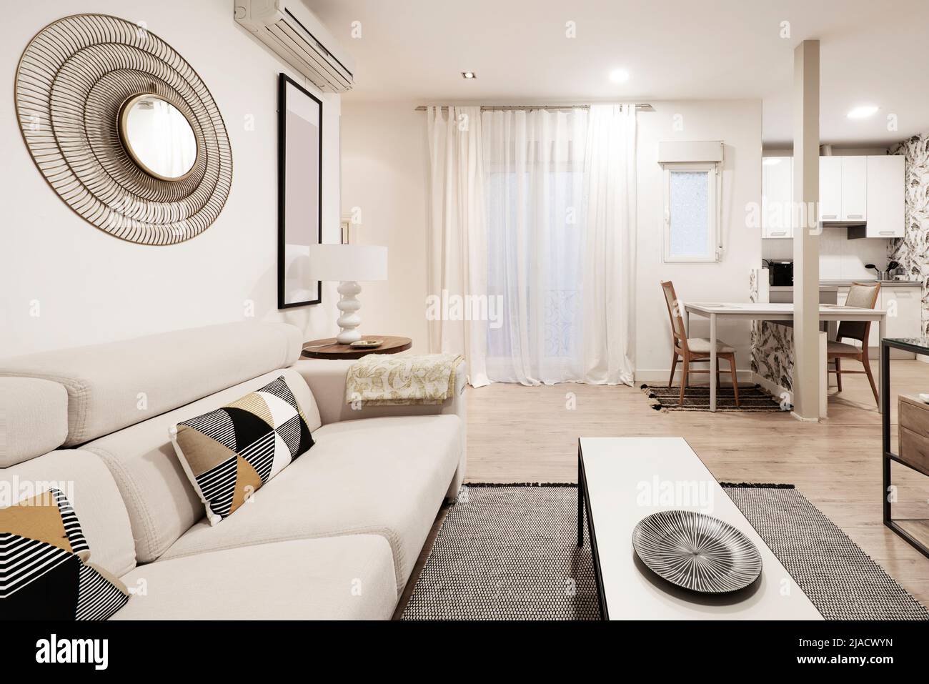 Living room with modern kitchen in the background, dining table in the