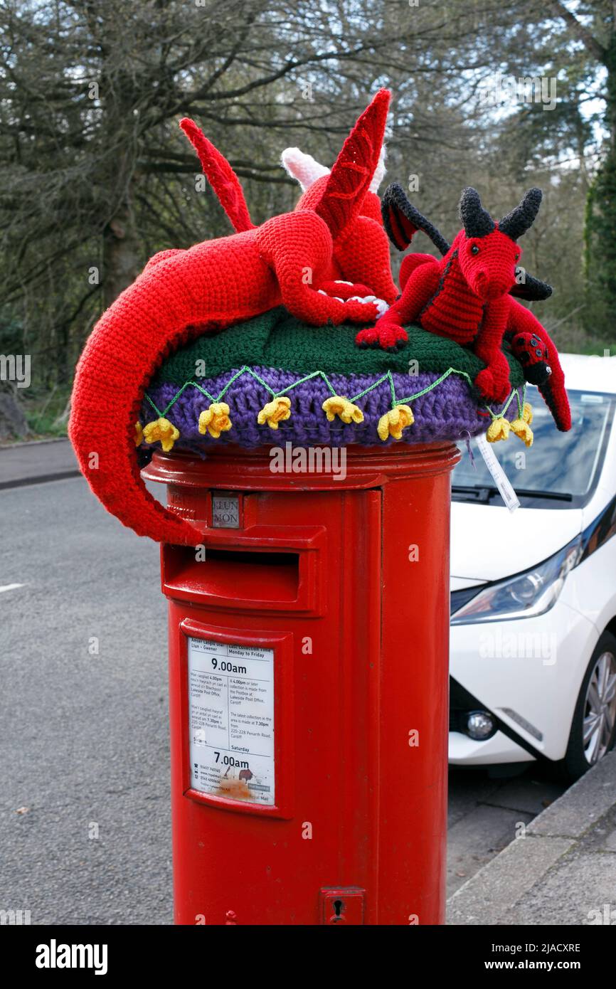 Welsh dragons and daffodils as a knitted crafted woollen postbox topper, Cardiff, Wales. Stock Photo