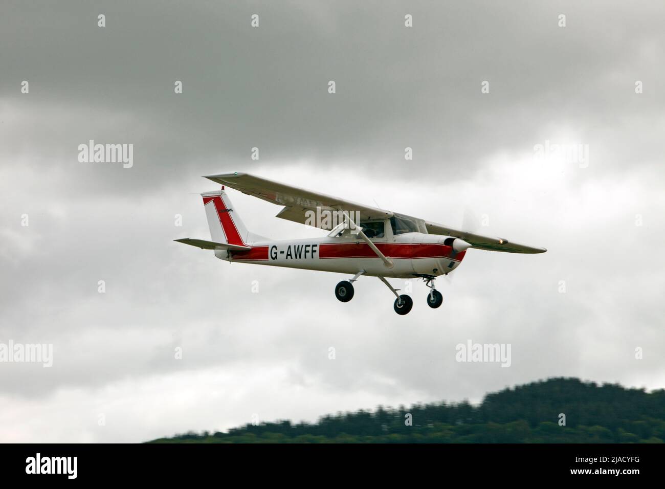 Cessna 150H coming in to land in drab poor weather. Stock Photo