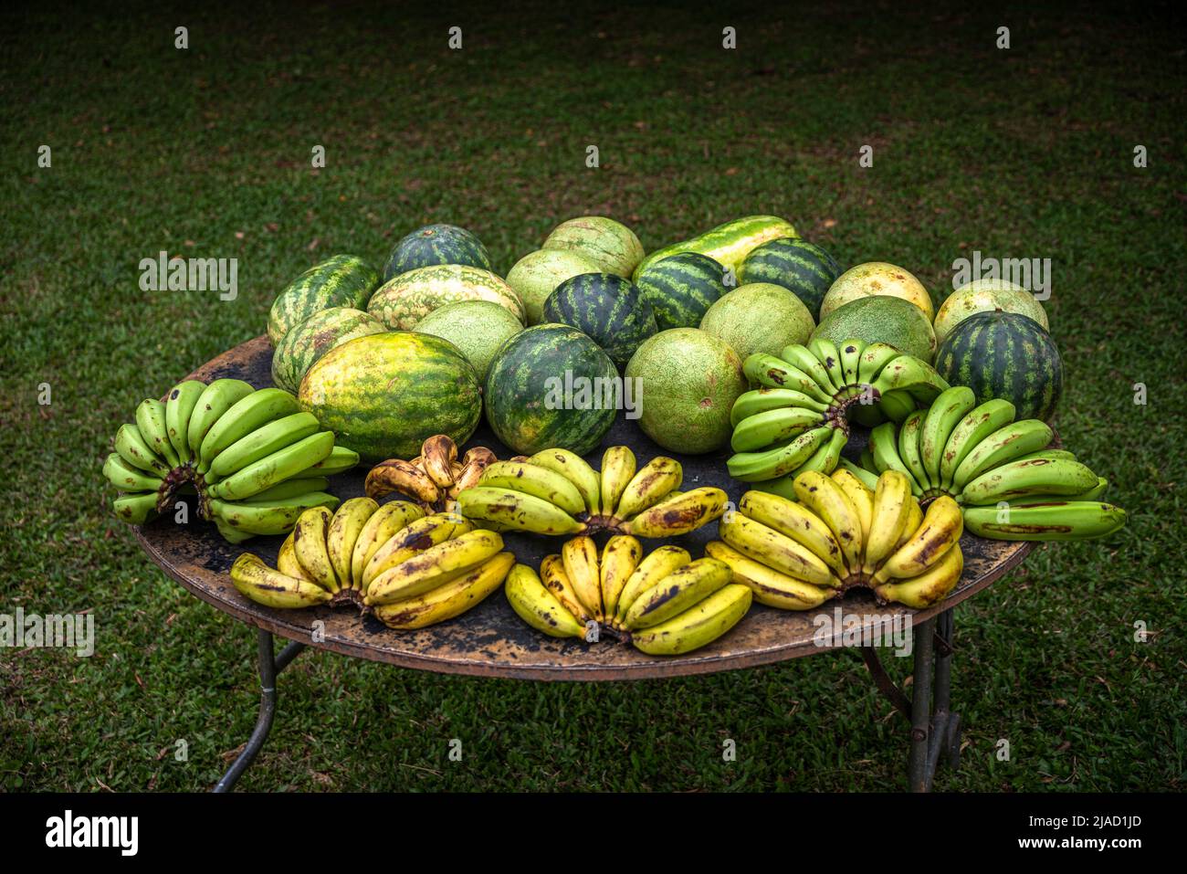 Bananas and watermelons on display on a round table at a country market in Panama Stock Photo