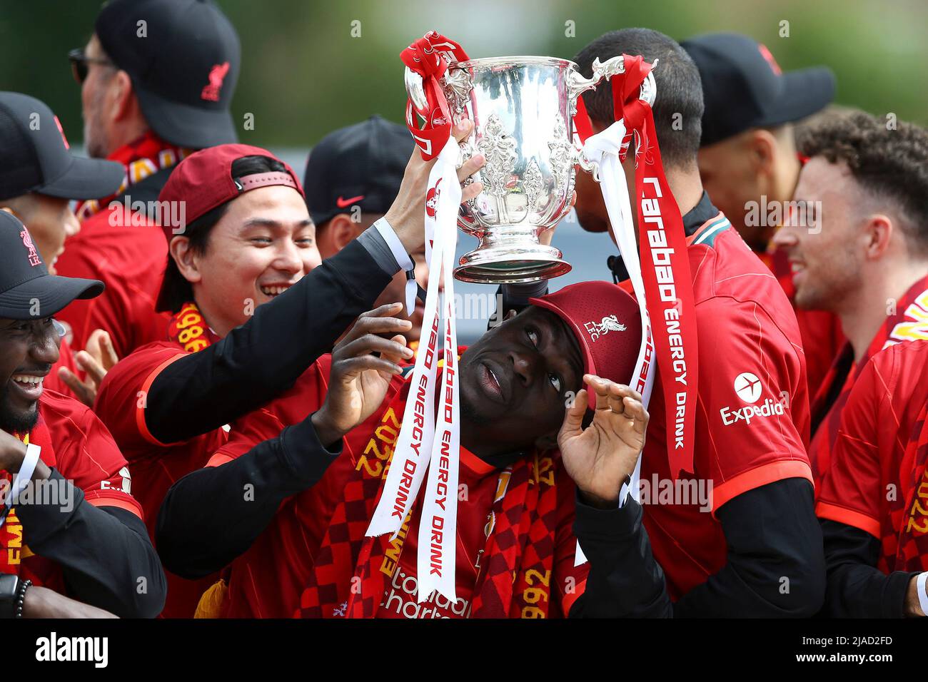 Liverpool, UK. 29th May, 2022. Takumi Minamino of Liverpool puts the Carabao Cup on the head of his teammate Sadio Mane of Liverpool. Liverpool Football Club victory parade in Liverpool on Sunday 29th May 2022. Liverpool FC celebrate this season's mens and women's teams achievements with an open top bus parade around Liverpool. Editorial use only. pic by Chris Stading/Andrew Orchard sports photography/Alamy Live news Credit: Andrew Orchard sports photography/Alamy Live News Stock Photo