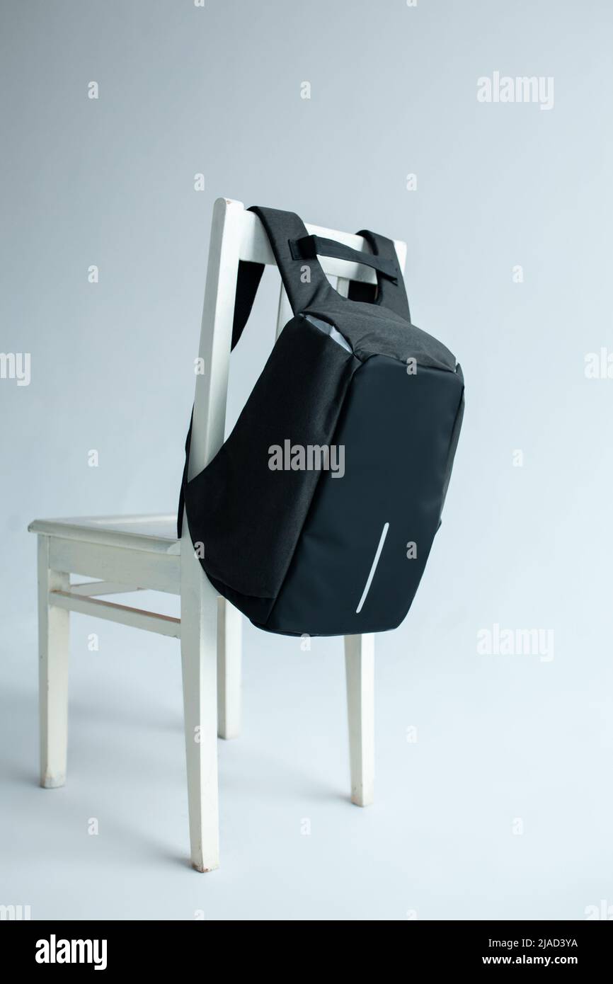 modern stylish backpack on chair studio shot Stock Photo