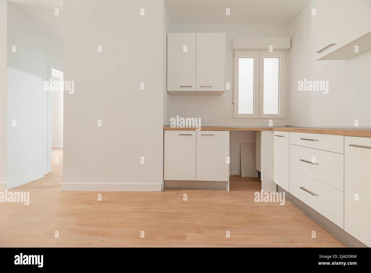 Photo of a newly installed kitchen awaiting appliances, open to a ...