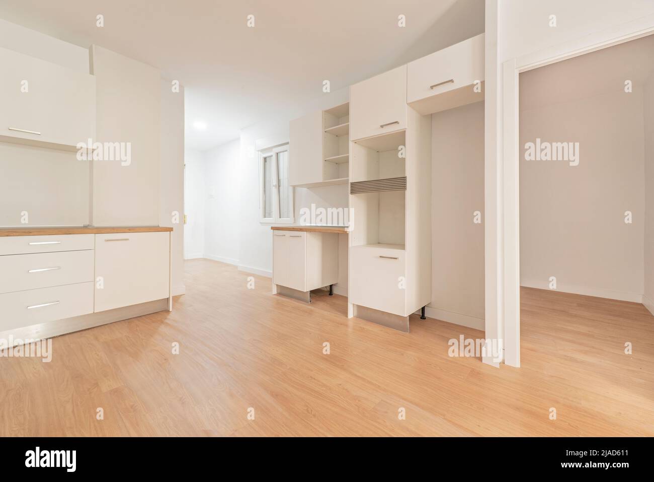 Photo of a newly installed kitchen awaiting appliances, open to a ...